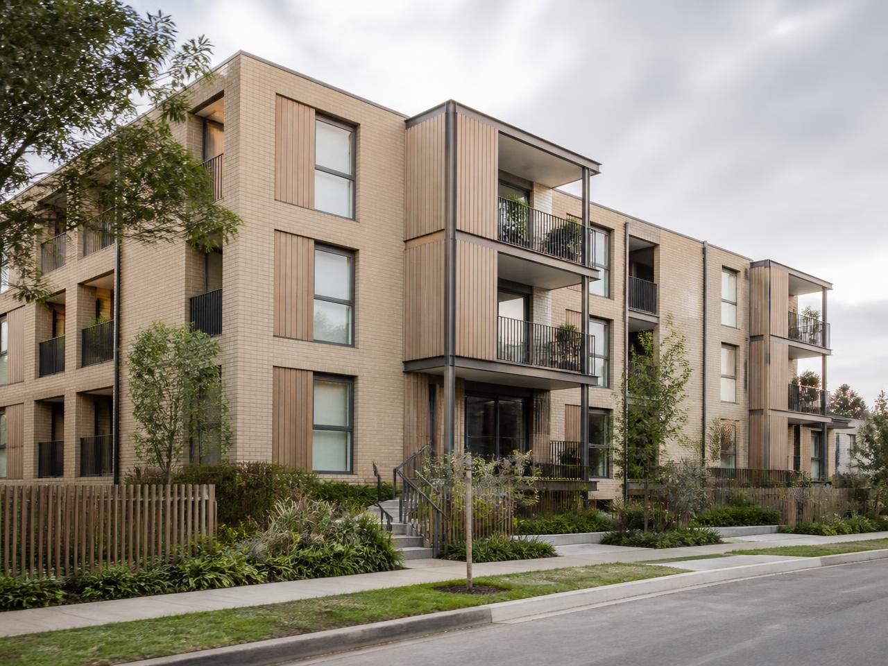 A well-kept low-rise apartment building with planted balconies